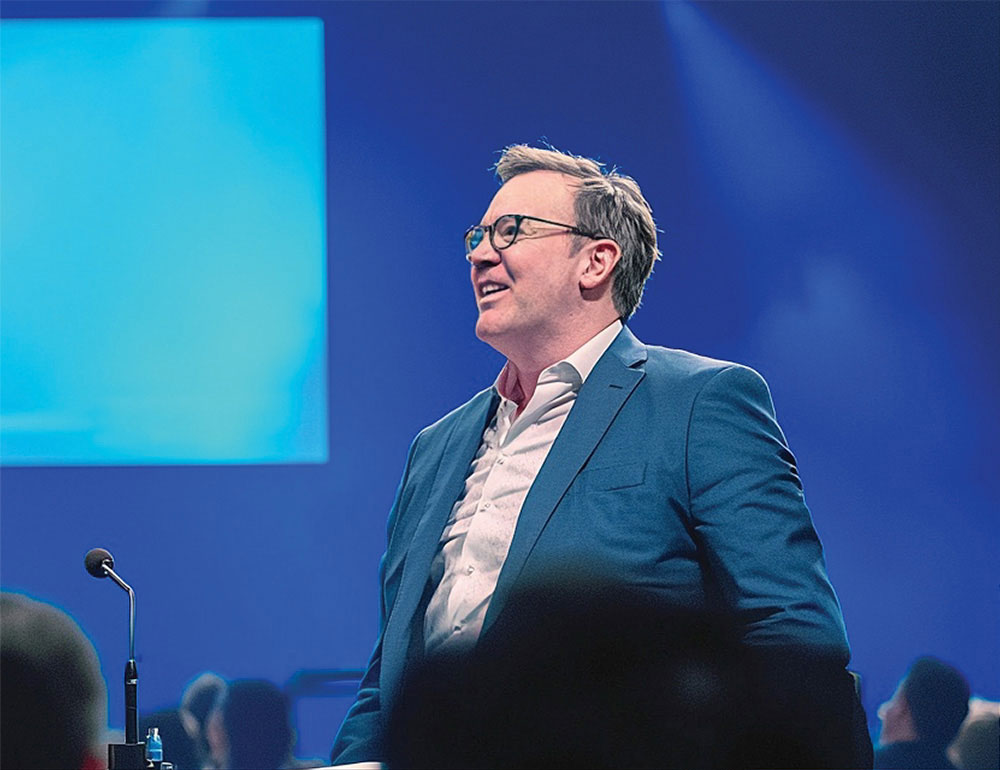 Blake Johnson presenting to an audience at a conference