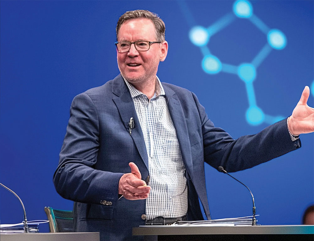 Speaker on stage at an AI and education conference