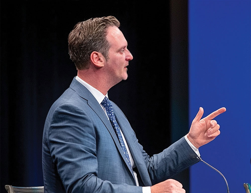 Phillip Hanson speaking on stage at an educator event