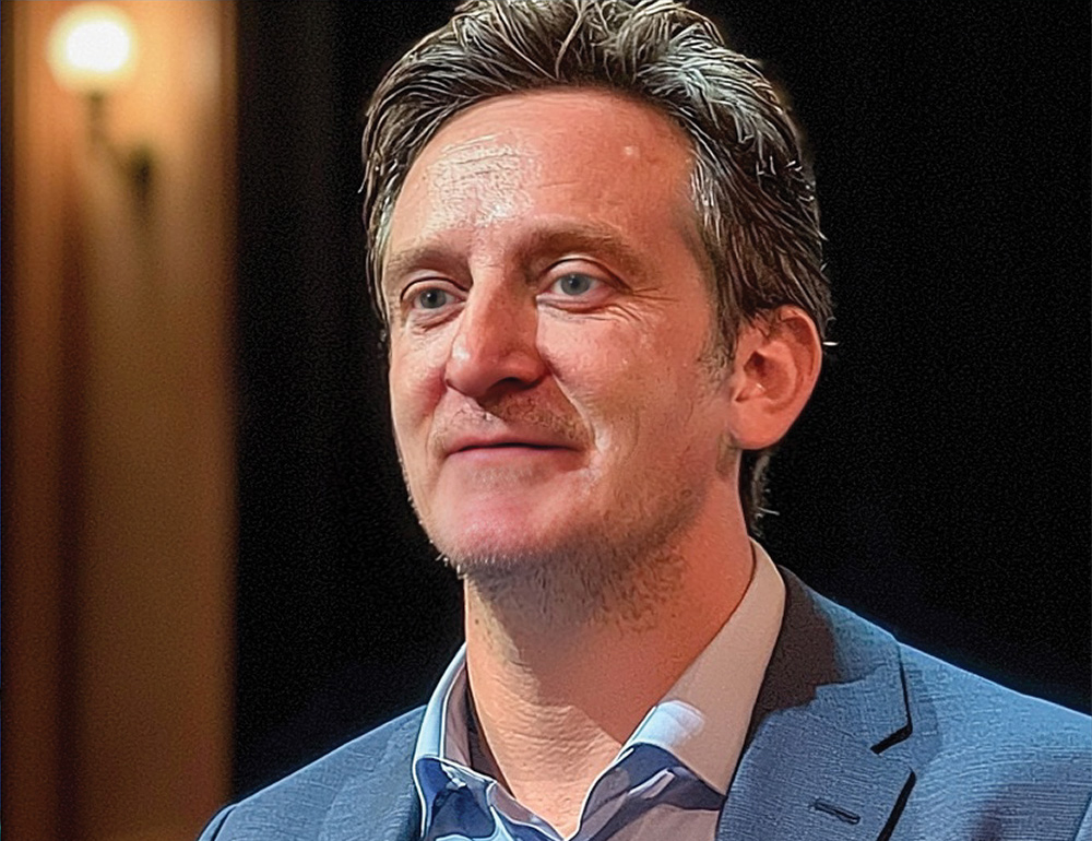 Conference audience engaged in an AI education session